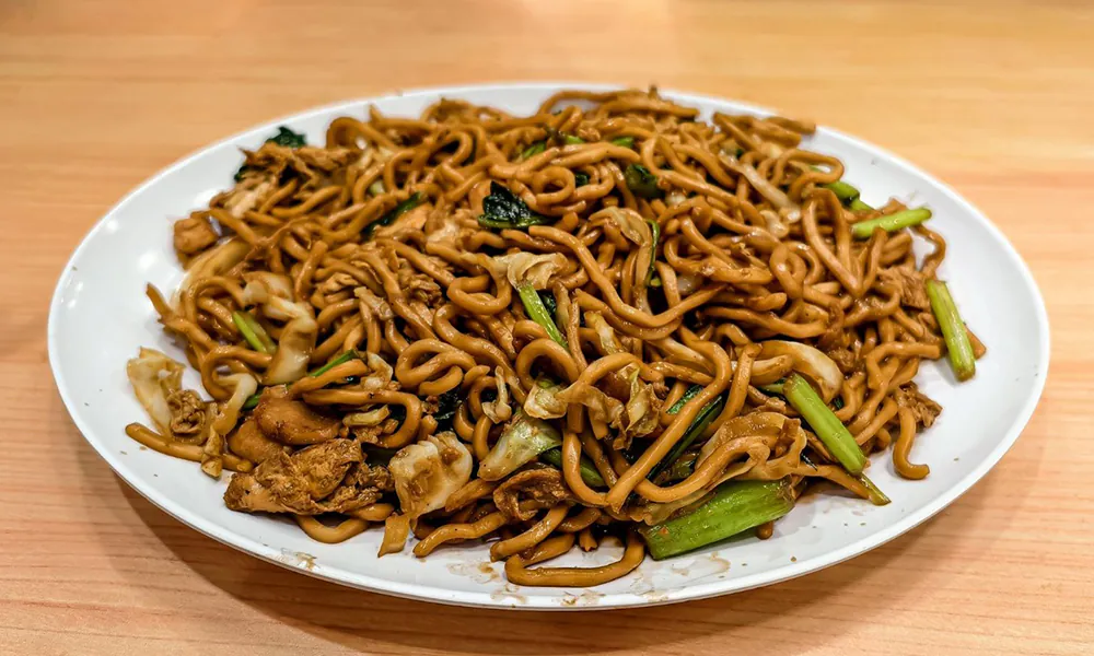 Savory stir-fried noodles with tender chicken and fresh vegetables at Golden Dragon Express, a Chinese Restaurant in San Antonio