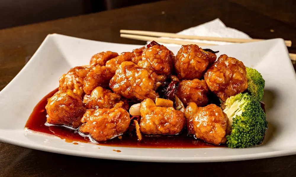 Crispy chicken in a sweet and spicy glaze, served with broccoli at Golden Dragon Express, a Chinese Restaurant in San Antonio